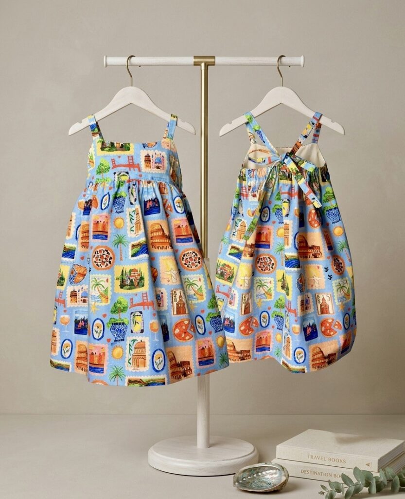 Hello World Sienna Sun Dress - organic cotton sundress with hand-painted travel stamp print